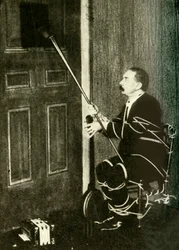 John Nevil Maskelyne performs a spirit cabinet illusion, c1910