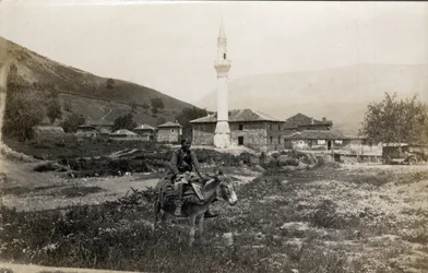 Macedonia, Greece: a man on a donkey in front of a minaret - Postcard 1914-1918