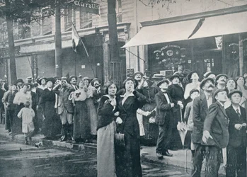 Paris crowd watching one of the German aeroplanes flying over the city, c1914