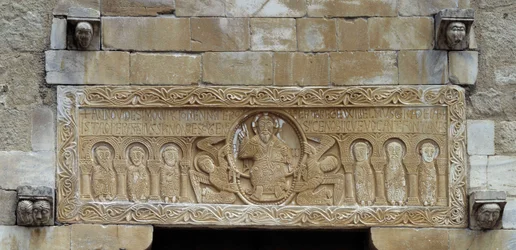 Romanesque Art: Lintel Representing a Group of Apostles Surrounding Christ Supported by Two Angels. Church of Saint Michael of Saint Genis des Fontaines. 11th Century (Eastern Pyrenees)