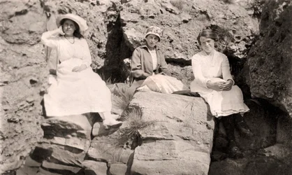 Three Women Relaxing on Rocks