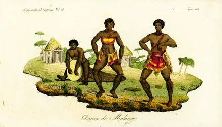 Two Mahungo women dancing the semba to music from a drum carved from a log in Angola