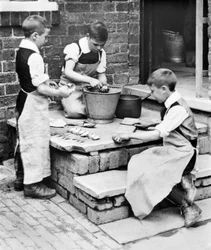 United Kingdom: Boys Peeling Potatoes and Sharpening Knives at the Workhouse Orphanage - Pontefract, c 1905