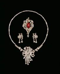 Art Deco diamond jewellery: baguette diamond brooch pendant, cabochon ruby and diamond scroll brooch, diamond pendant earrings