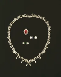 Art Deco scroll and leaf design necklace; ruby and diamond baguette cluster ring; sapphire and diamond three stone ring; emerald and diamond three stone ring