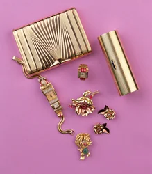 Selection of Art Deco jewellery: two cigarette cases; ruby cluster flower brooch and earrings; cocktail watch