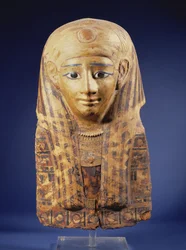 Cartonnage mummy head-dress with lappet wig, the eyes inlaid with obsidian and alabaster, Egyptian, Late Period (644-332 BC)