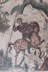 Detail of the little hunt mosaic. A hunter is about to spear a hare. 3rd - 4th century. Roman Villa of the Casale, Sicily. UNESCO site.