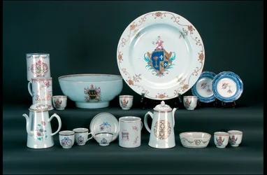 Dinner service including a pair of famille rose armorial saucers