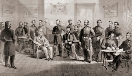 General Ulysses S. Grant (seated centre right) and General Robert E. Lee (seated centre left) with their respective staff at the Appomattox Courthouse, Virginia where General Lee surrendered the Army of North Virginia and thus ended the American Civil War