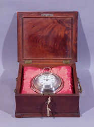 Marine watch, in silver pair-case, lying on cushions in mahogany carrying case, by John Harrison and Son