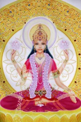 Picture showing Lakshmi, Goddess of wealth and consort of Lord Vishnu, sitting holding lotus flowers
