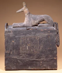 Pylon-shaped shabti-box with an inscription and a statue of Anubis as a jackal on the lid, Egyptian, from Thebes, early 22nd Dynasty, c.900 BC