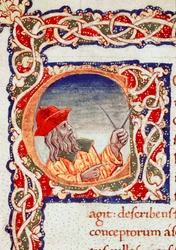 Greek astronomer Claudius Ptolemy (Claudius Ptolemaeus) (around 90-around 168 AD) using a compass to make calculations. Miniature taken from “Cosmographia” (Ms. V.F. 32 f.2r), Naples, National Library