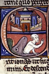 Jonah, after three days and three nights spent in the belly of a huge fish, is vomited by the animal. 14th century manuscript. Biblioteca nazionale braidense, Milan.