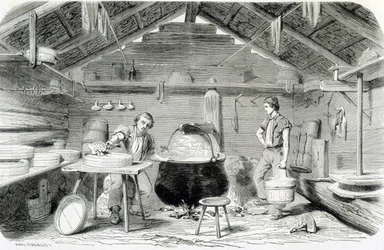 Making Gruyère cheese in a Swiss chalet, or cheese factory in the Alps - in 