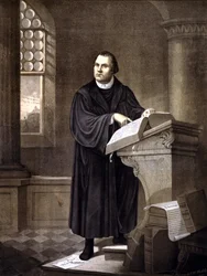 Martin Luther (1483 - 1546) reading in a church