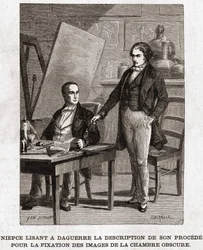 Niepce reading to Louis Daguerre the description of Heliography, for the fixing of pictures from camera obscura - Nicephore Niepce (1765-1833), French inventor, pioneer of photography reading to Daguerre the description of his method for fixing the images