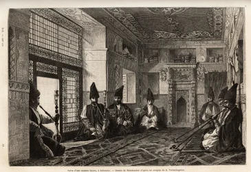 The living room of a rich Tatar house in Schusha (Transcaucasia, Russia), where men gather, sitting on carpets to smoke the pipe and chat. Engraving to illustrate the voyage in the provinces of the Caucasus, by Basile Vereschaguine, in 1864-1865, published