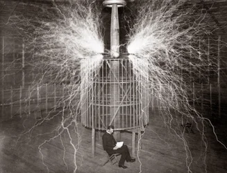 Nikola Tesla Sitting in His Colorado Springs Laboratory with His 