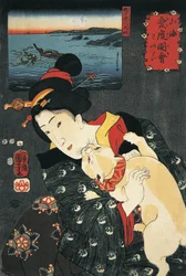 Close-up of a young woman with a cat in her arms