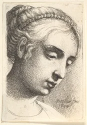 Woman with string of pearls in her hair looking downwards to the right