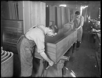 Adjusting the sides and bottom of the shell of a wooden casket, Oneida, New York, April 3, 1916
