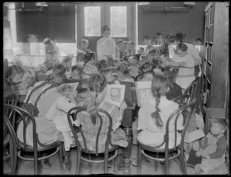 Children reading in the reading room of an unidentified branch of the Queens Borough Public Library, c.1910