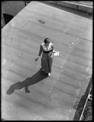 Girl stenographer on roof with pad