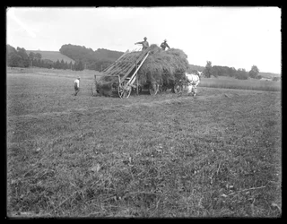 Hay wagon, farm workers and children, showing apparatus for lifting the hay, McCready Farm, Crawford County, Pennsylvania, c.1913