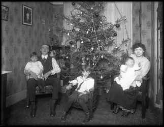 Informal Group Portrait of Unidentified Family in Their Apartment Seated in Front of a Christmas Tree, New York City