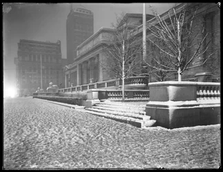 Night view of the Fifth Avenue facade of the main branch of the New York Public Library in the snow, 42nd Street and Fifth Avenue, New York City, March 6, 1915