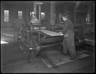 Running Lumber Intended for Use in Casket Manufacture Through a Double-Surface Planer, Oneida, New York, April 3, 1916