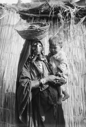 A Bedouin woman carrying her child, Beersheba