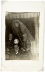 Paranormal Phenomenon: Portrait of Three Elderly People, the Spirit of a Woman Appearing Behind Them